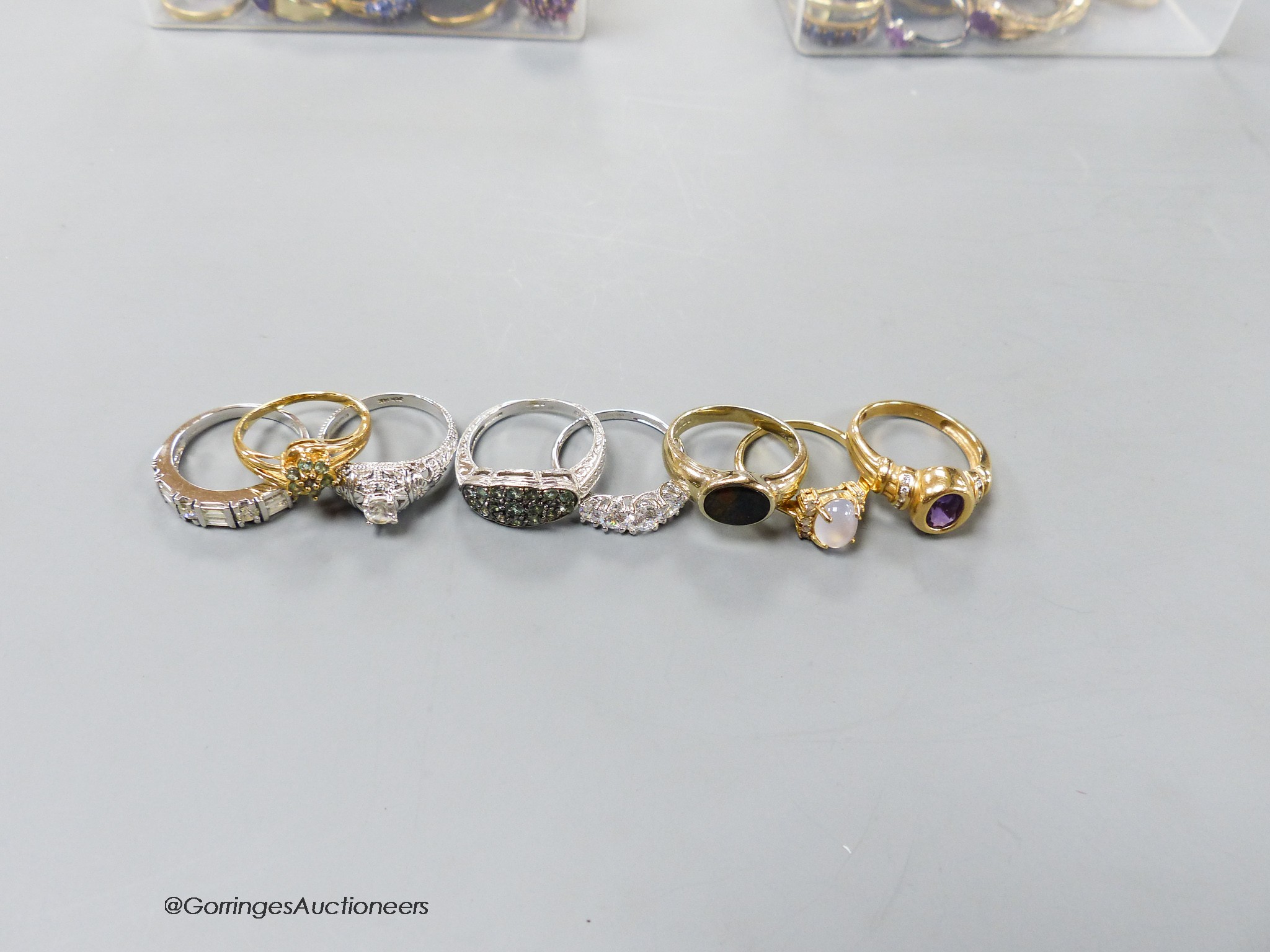 Fourteen assorted modern 14k white or yellow metal and gem set dress rings, gross 29 grams.